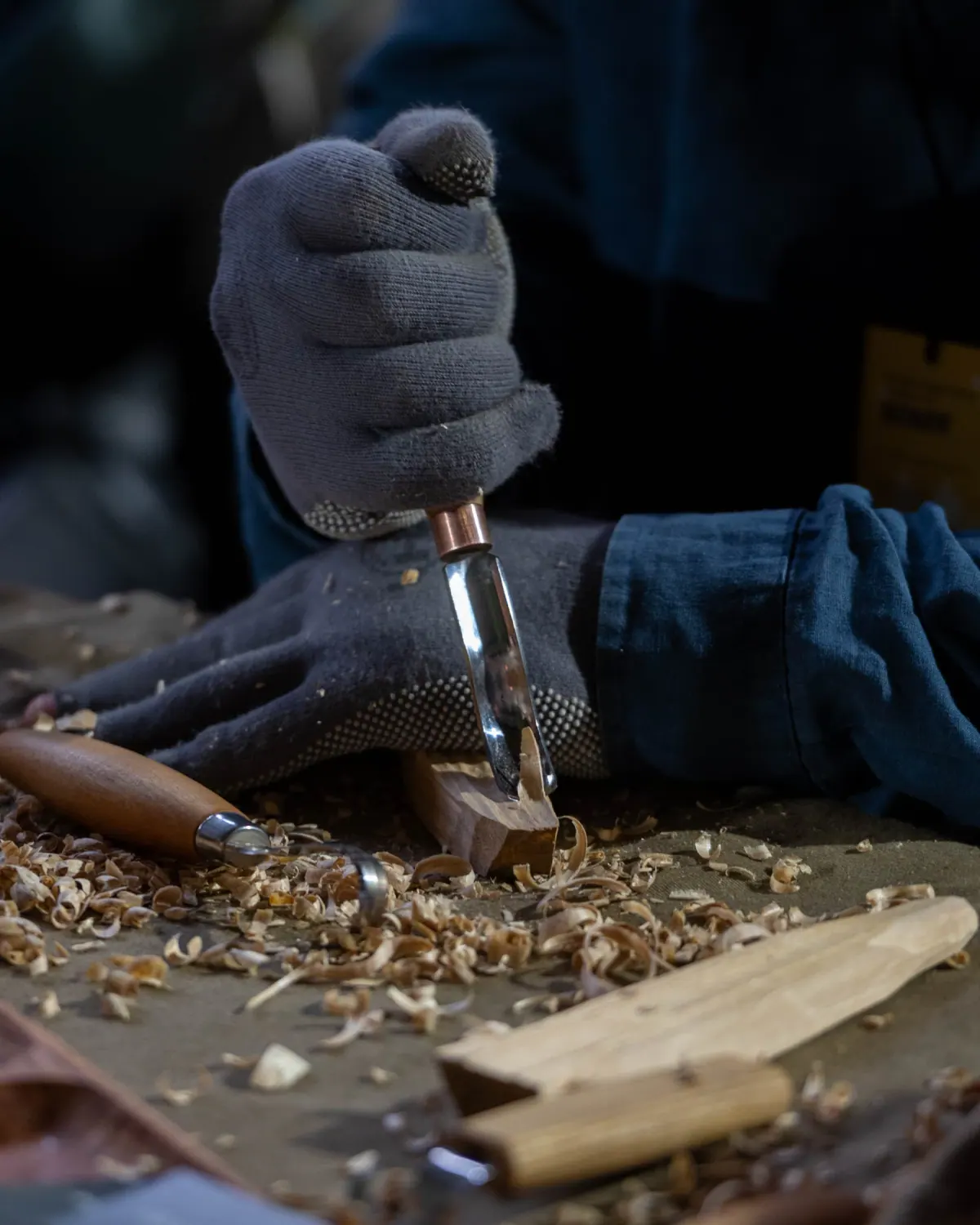 Hands carving wood with a chisel, illustrative stock photograph